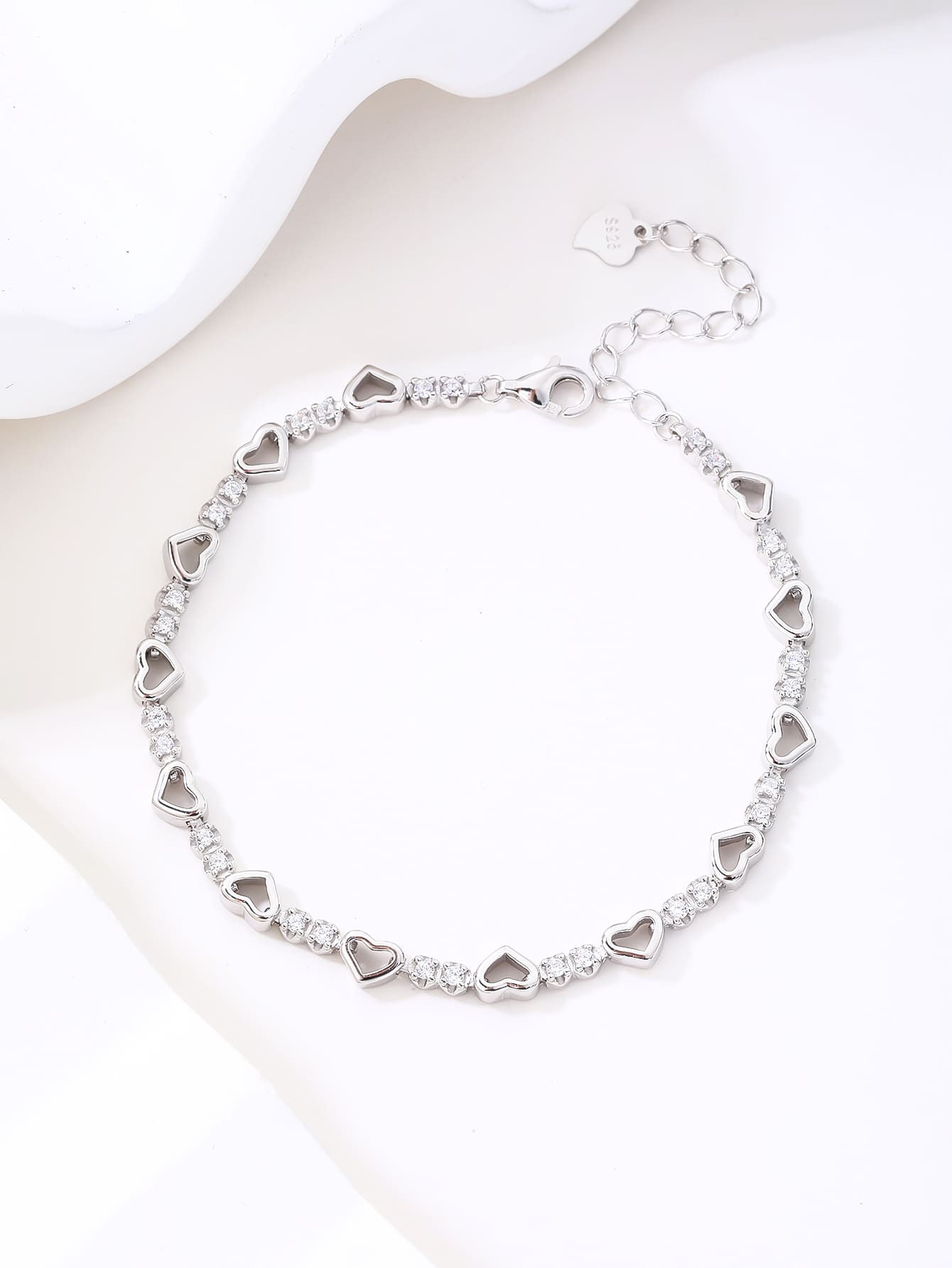 heart bracelet with zirconia stones in hallmarked, rhodium-plated 925 sterling silver – worn view – DRESCHER Jewellery®
