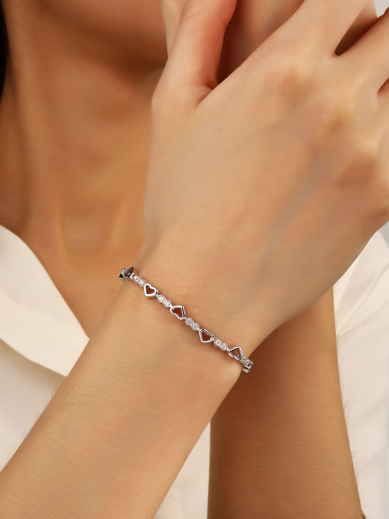 heart bracelet with zirconia stones in hallmarked, rhodium-plated 925 sterling silver – lifestyle view – DRESCHER Jewellery®
