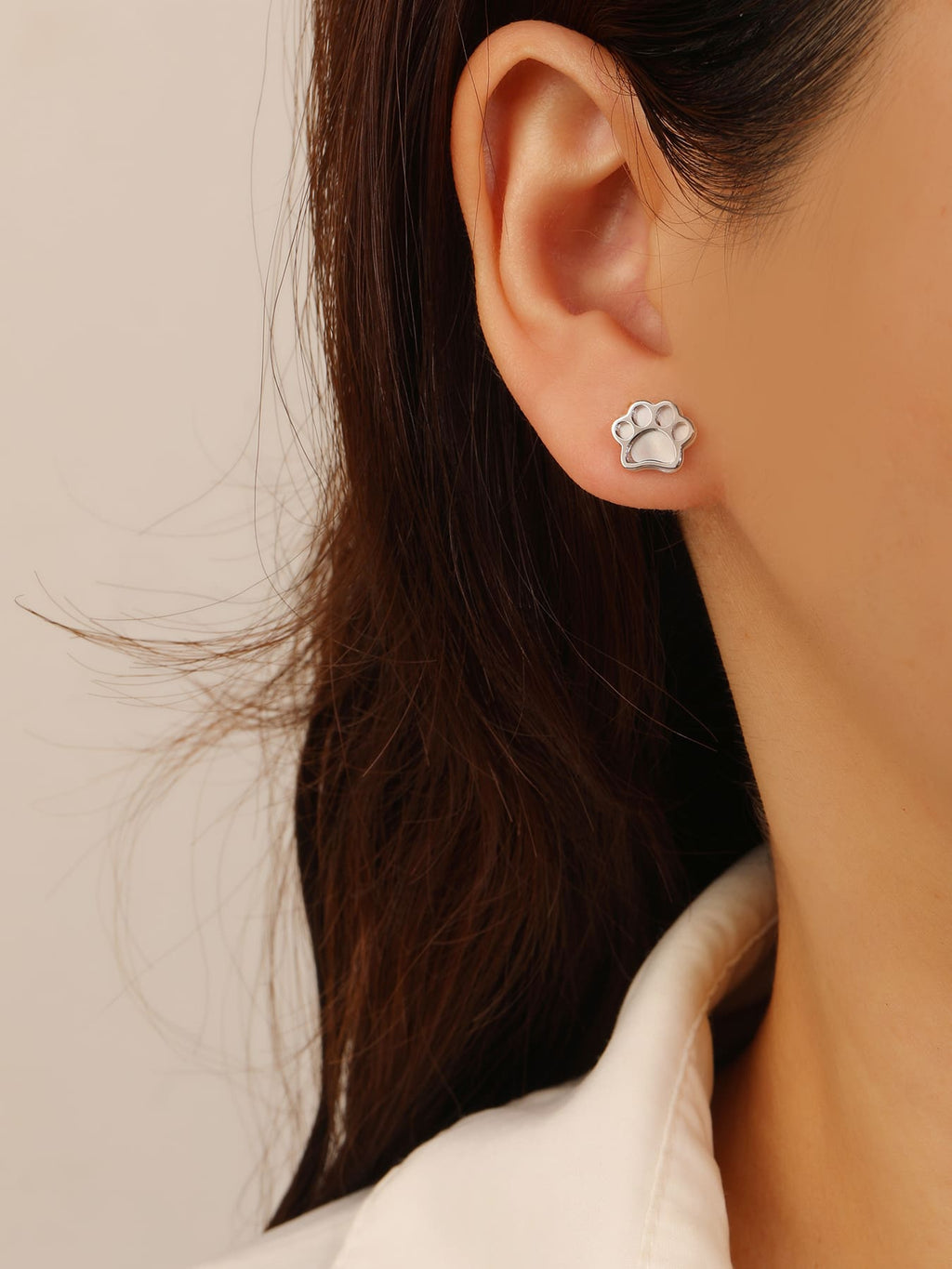Paw-print stud earrings with mother-of-pearl inlays and silver components crafted from hallmarked, rhodium-plated 925 sterling silver – worn view – DRESCHER Jewellery®