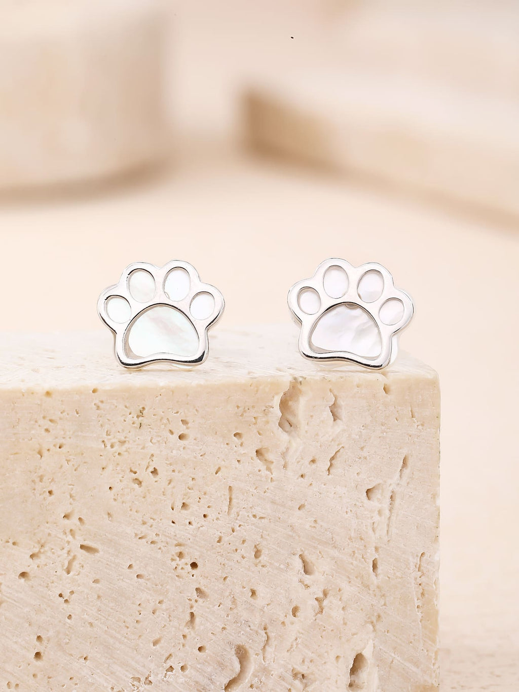 Paw-print stud earrings with mother-of-pearl inlays and silver components crafted from hallmarked, rhodium-plated 925 sterling silver – lifestyle view – DRESCHER Jewellery®