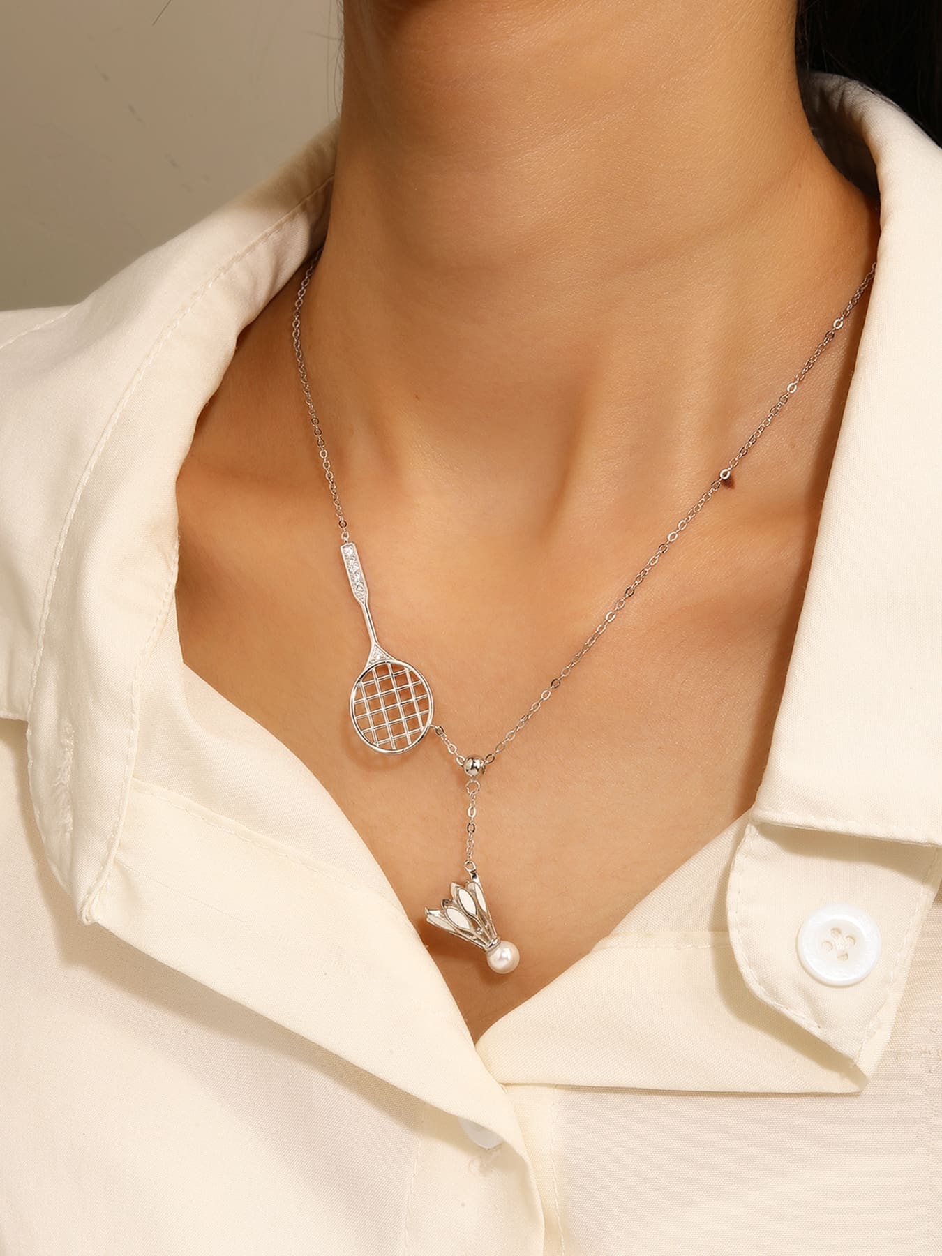 Silver badminton and badminton ball pendant necklace with white cubic zirconia and pearl