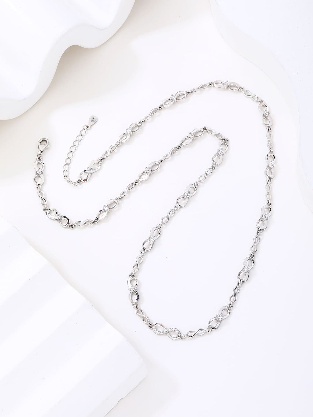 infinity sign necklace with zirconia stones (44+4 cm) in hallmarked, rhodium-plated 925 sterling silver – detail view – DRESCHER Jewellery®