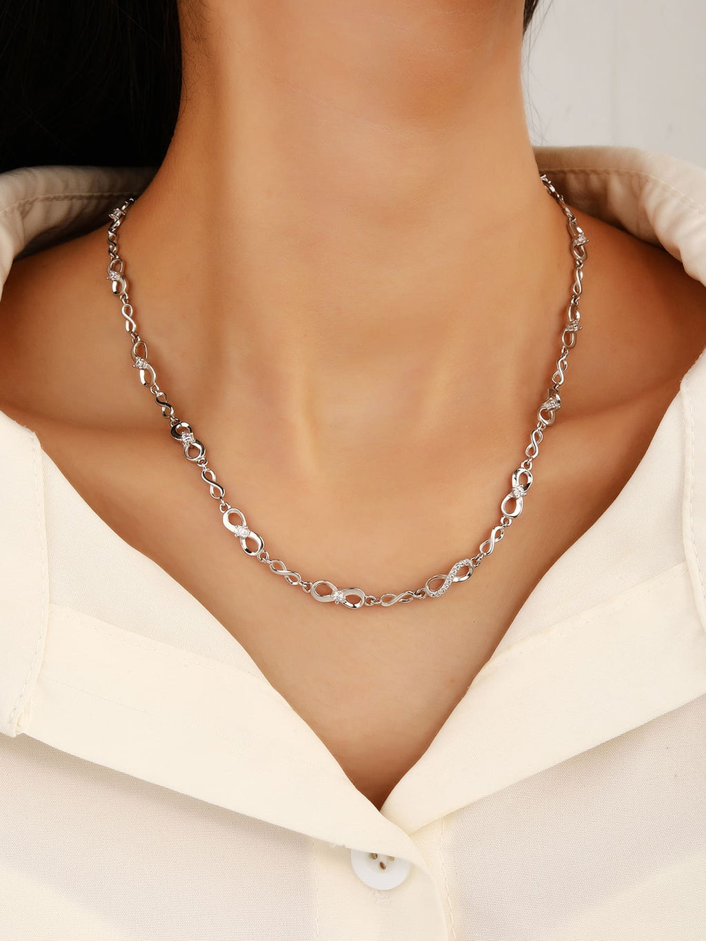 infinity sign necklace with zirconia stones (44+4 cm) in hallmarked, rhodium-plated 925 sterling silver – worn view – DRESCHER Jewellery®