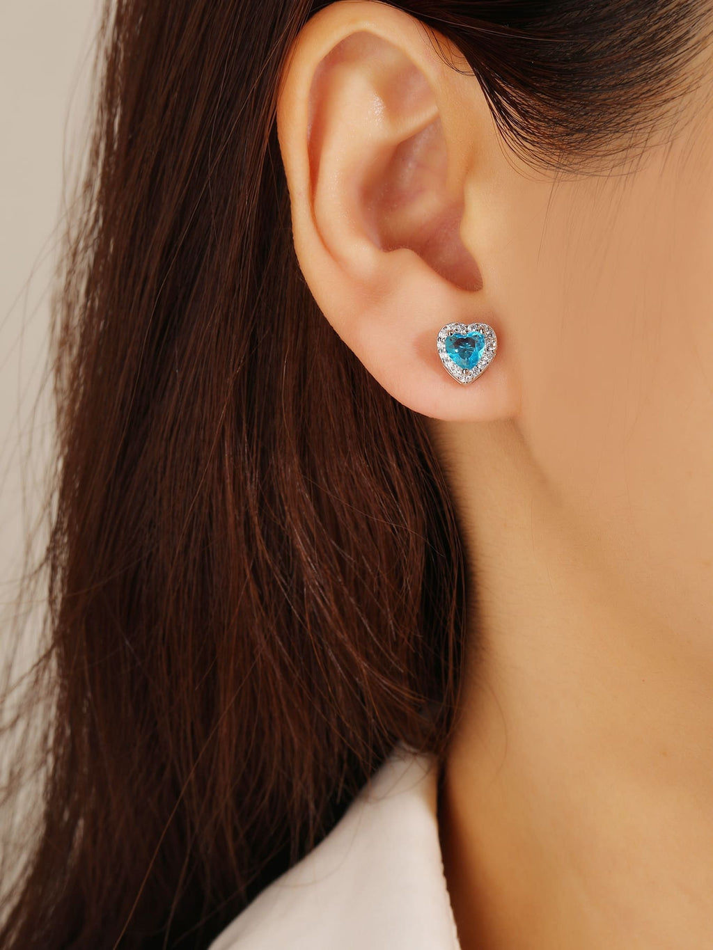light blue heart shaped stone stud earrings with white cubic zirconia in hallmarked, rhodium-plated 925 sterling silver – worn view – DRESCHER Jewellery®