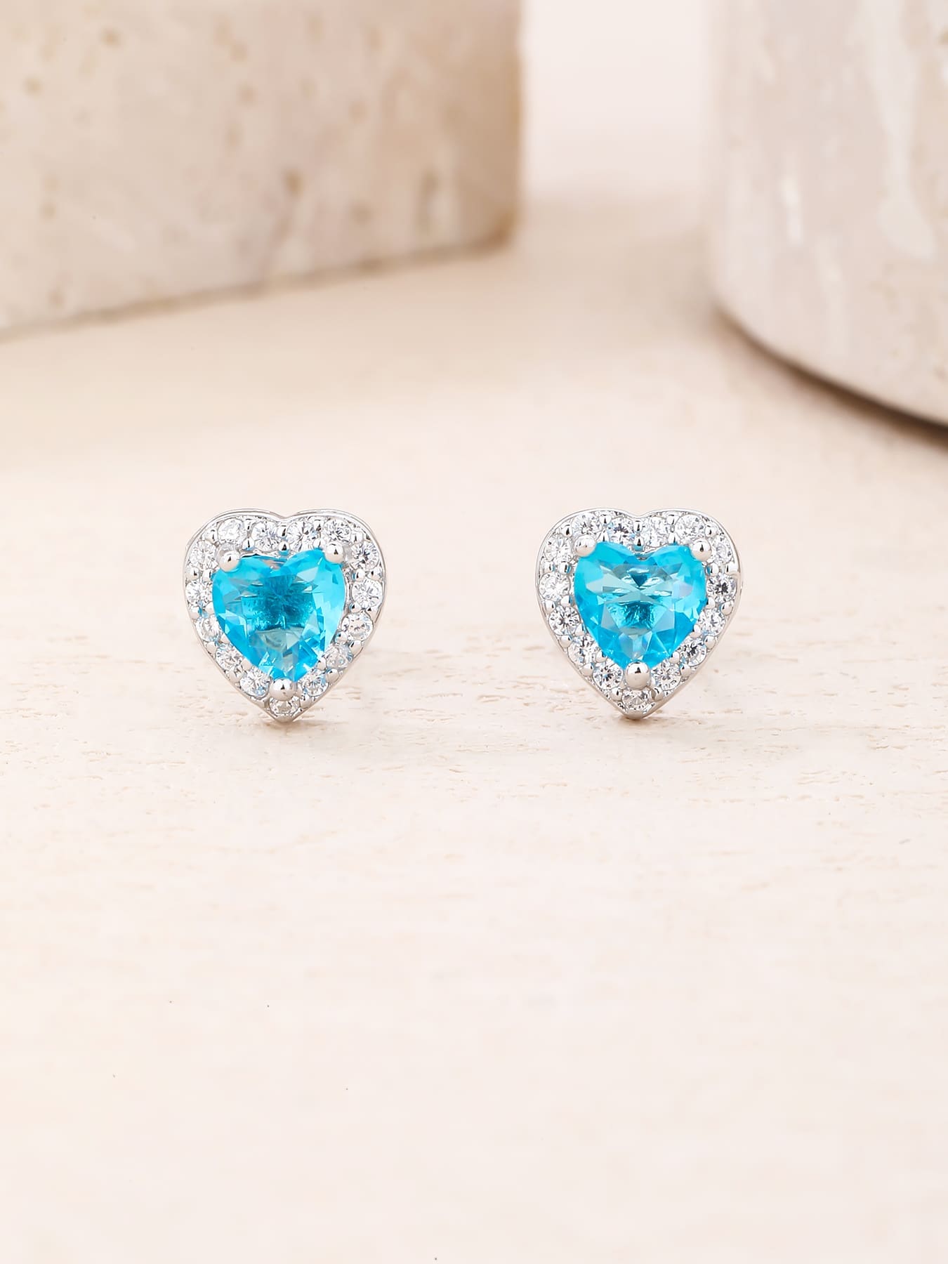 light blue heart shaped stone stud earrings with white cubic zirconia in hallmarked, rhodium-plated 925 sterling silver – lifestyle view – DRESCHER Jewellery®