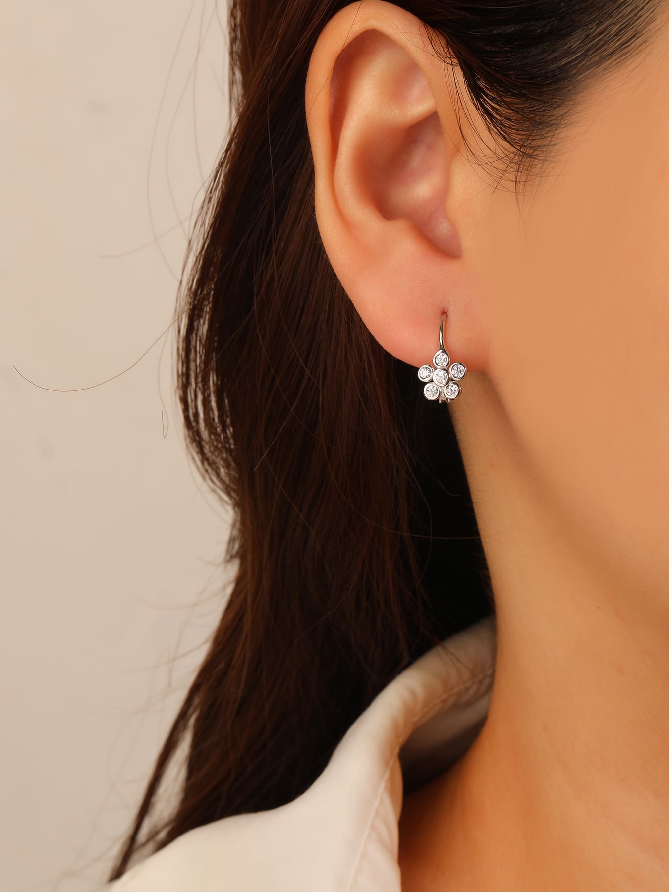 Six-petal flower white cubic zirconia leverback earrings in hallmarked, rhodium-plated 925 sterling silver – worn view – DRESCHER Jewellery®