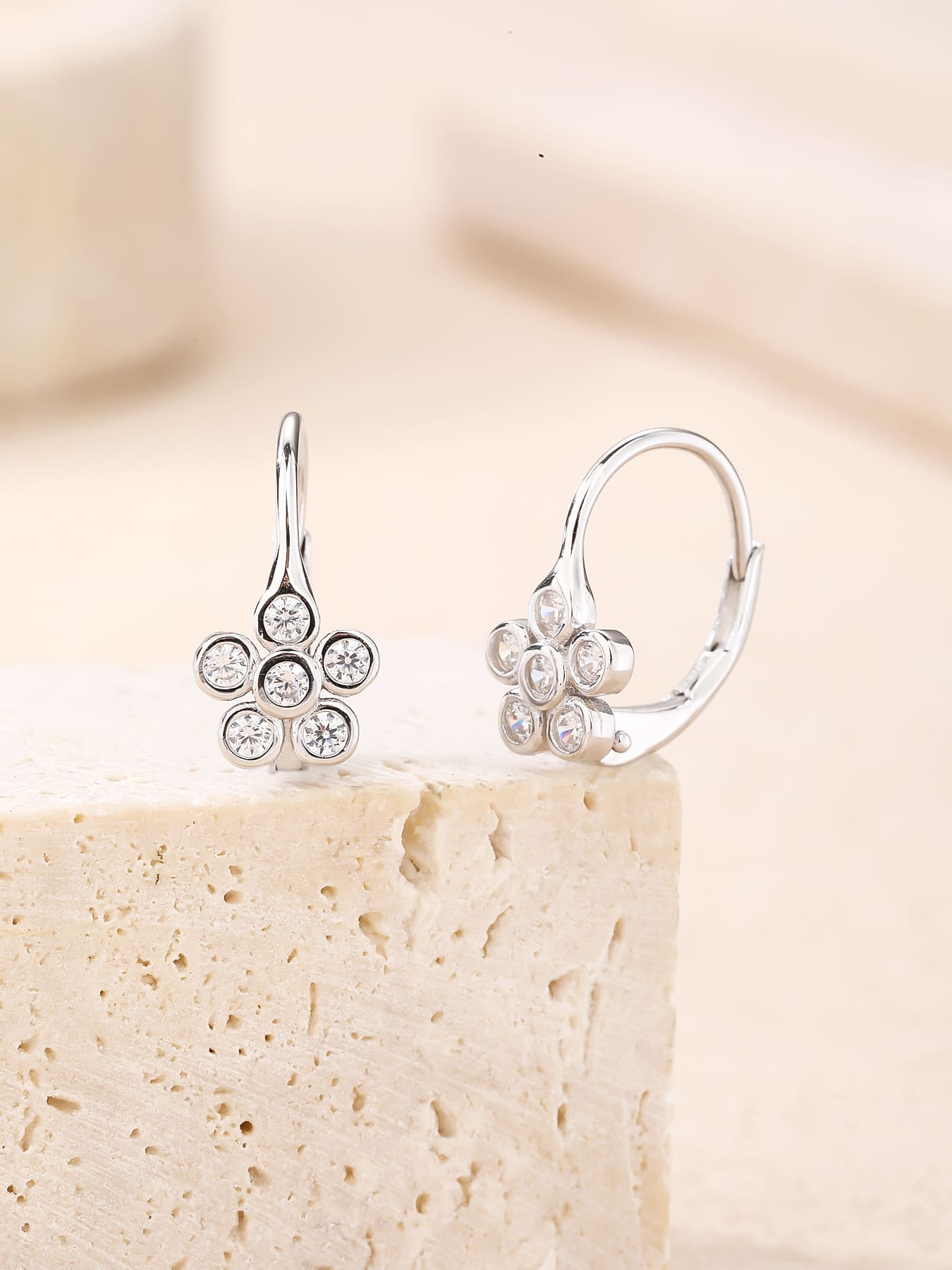 Six-petal flower white cubic zirconia leverback earrings in hallmarked, rhodium-plated 925 sterling silver – lifestyle view – DRESCHER Jewellery®