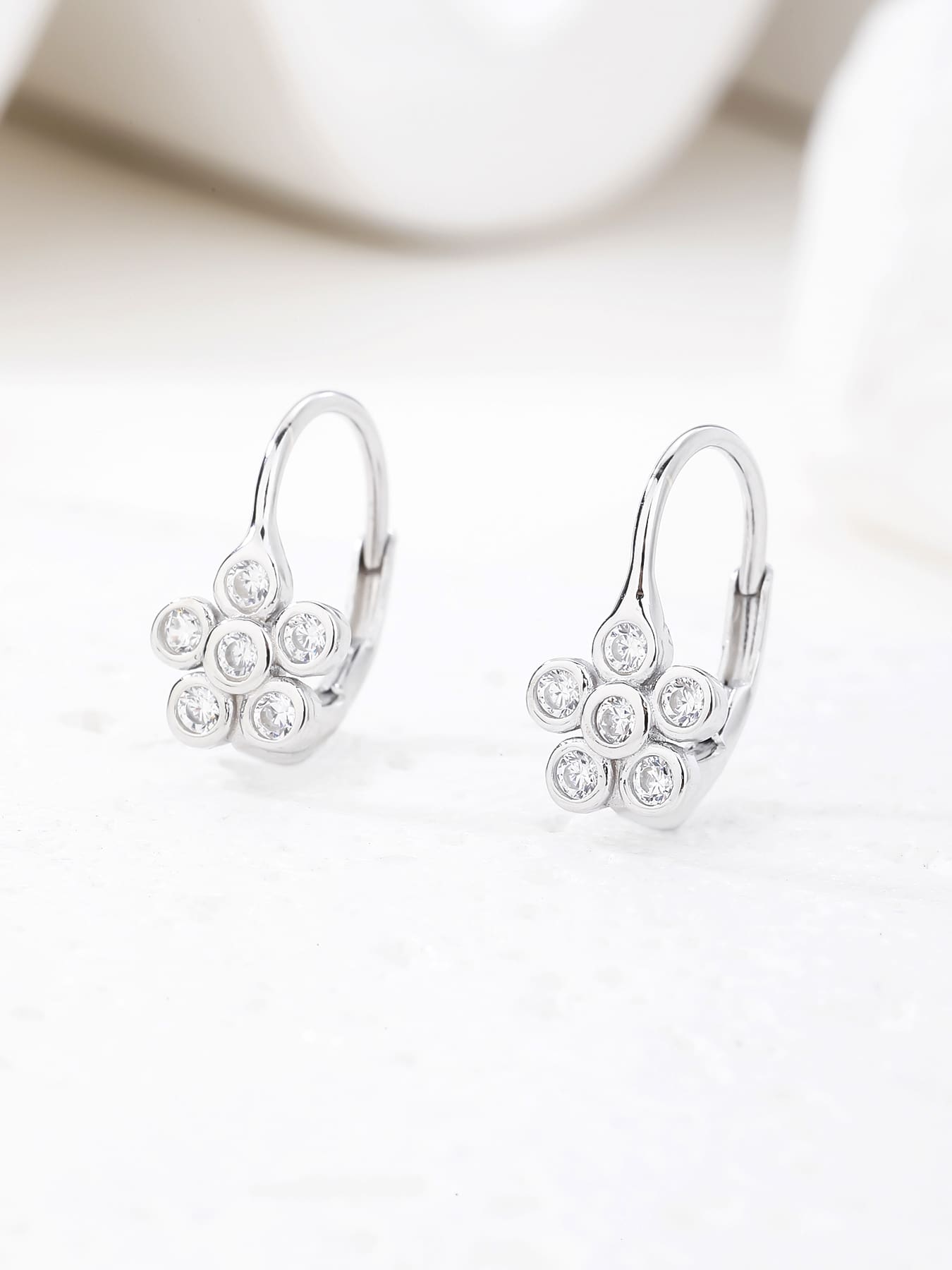 Six-petal flower white cubic zirconia leverback earrings in hallmarked, rhodium-plated 925 sterling silver – display view – DRESCHER Jewellery®