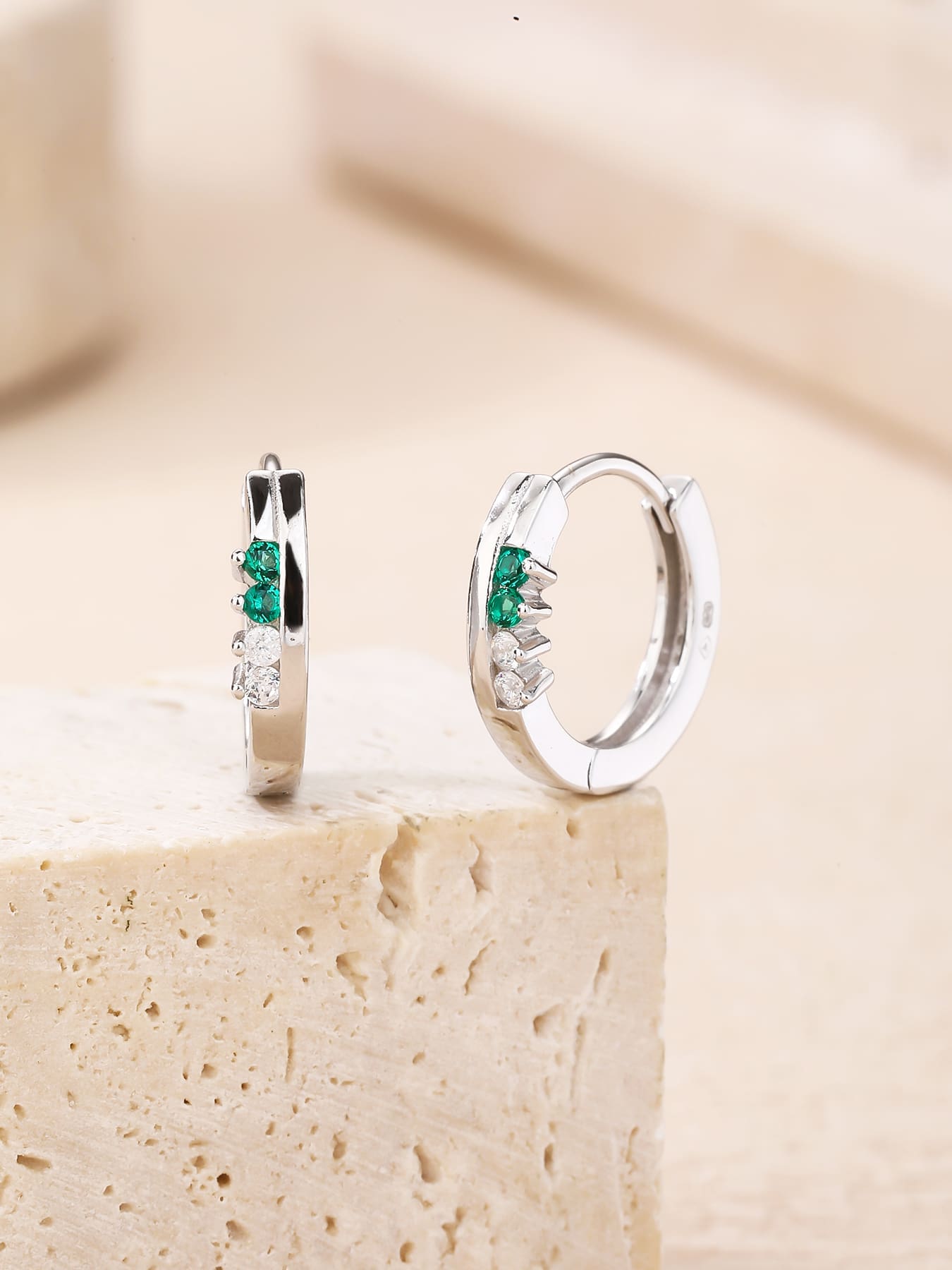 Green and white cubic zirconia hoop earrings in hallmarked, rhodium-plated 925 sterling silver – lifestyle view – DRESCHER Jewellery®
