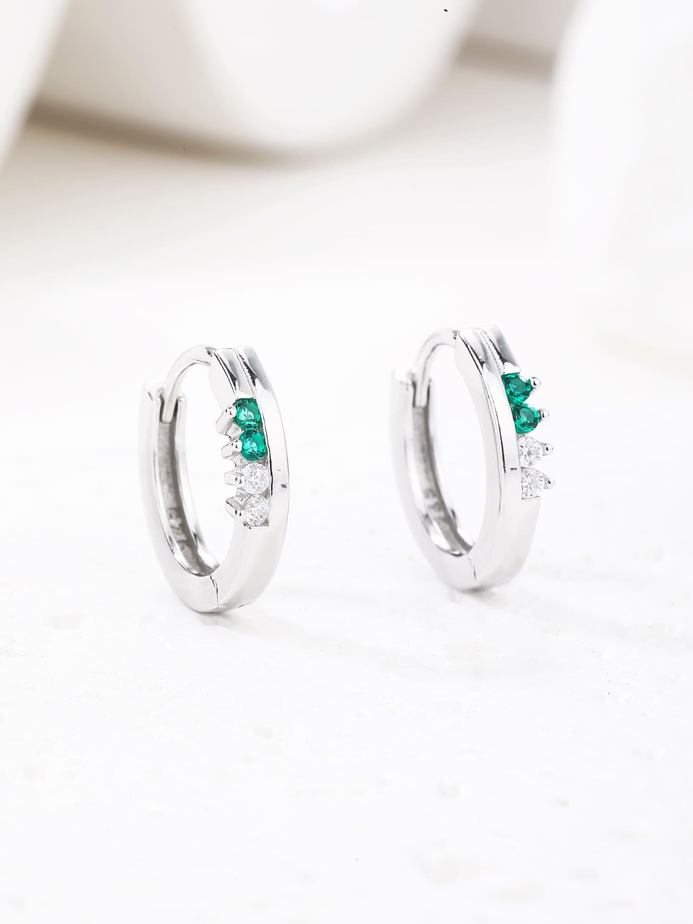 Green and white cubic zirconia hoop earrings in hallmarked, rhodium-plated 925 sterling silver – display view – DRESCHER Jewellery®