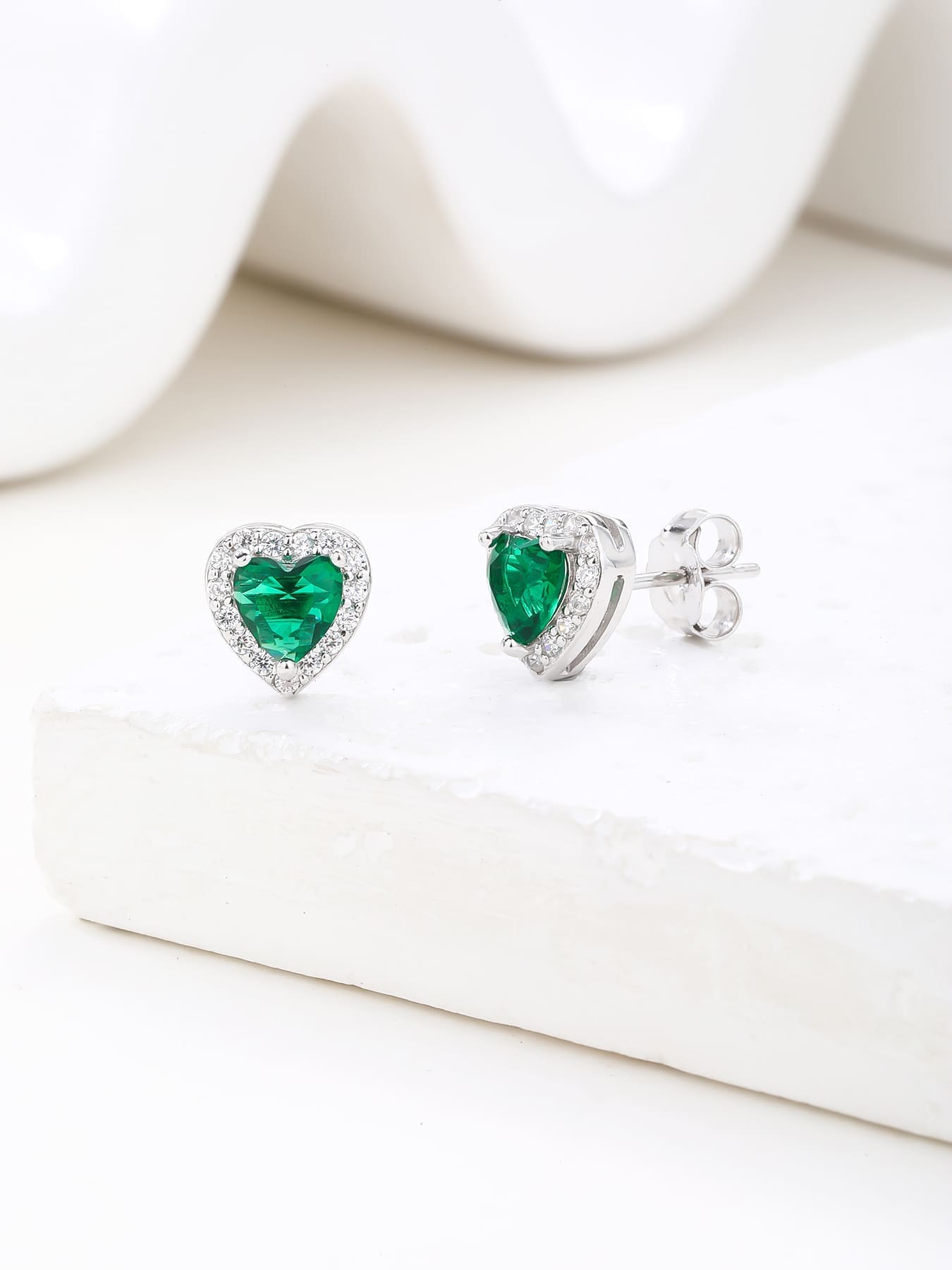 Green heart and white cubic zirconia stud earrings in hallmarked, rhodium-plated 925 sterling silver – display view – DRESCHER Jewellery®