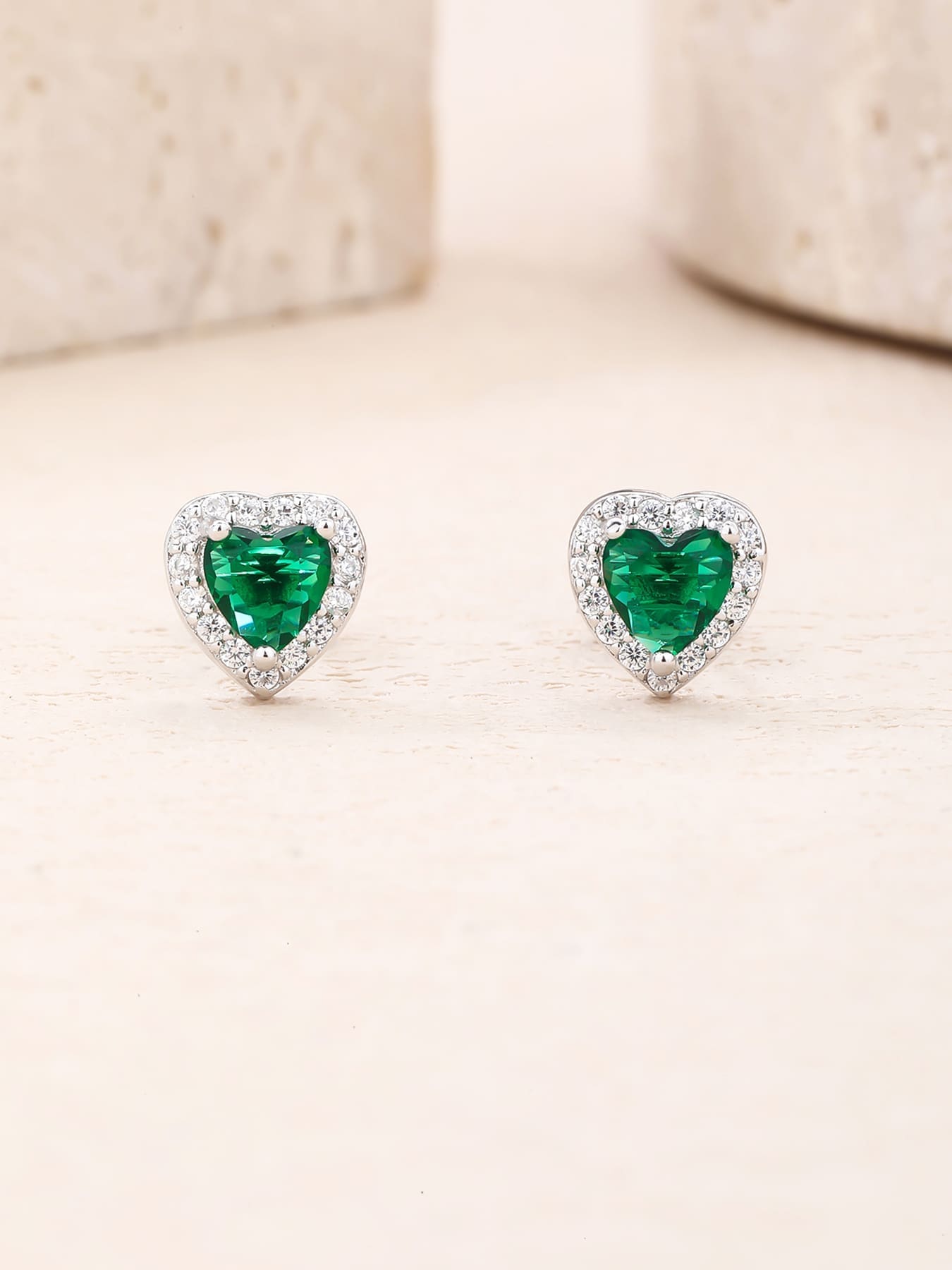 Green heart and white cubic zirconia stud earrings in hallmarked, rhodium-plated 925 sterling silver – lifestyle view – DRESCHER Jewellery®