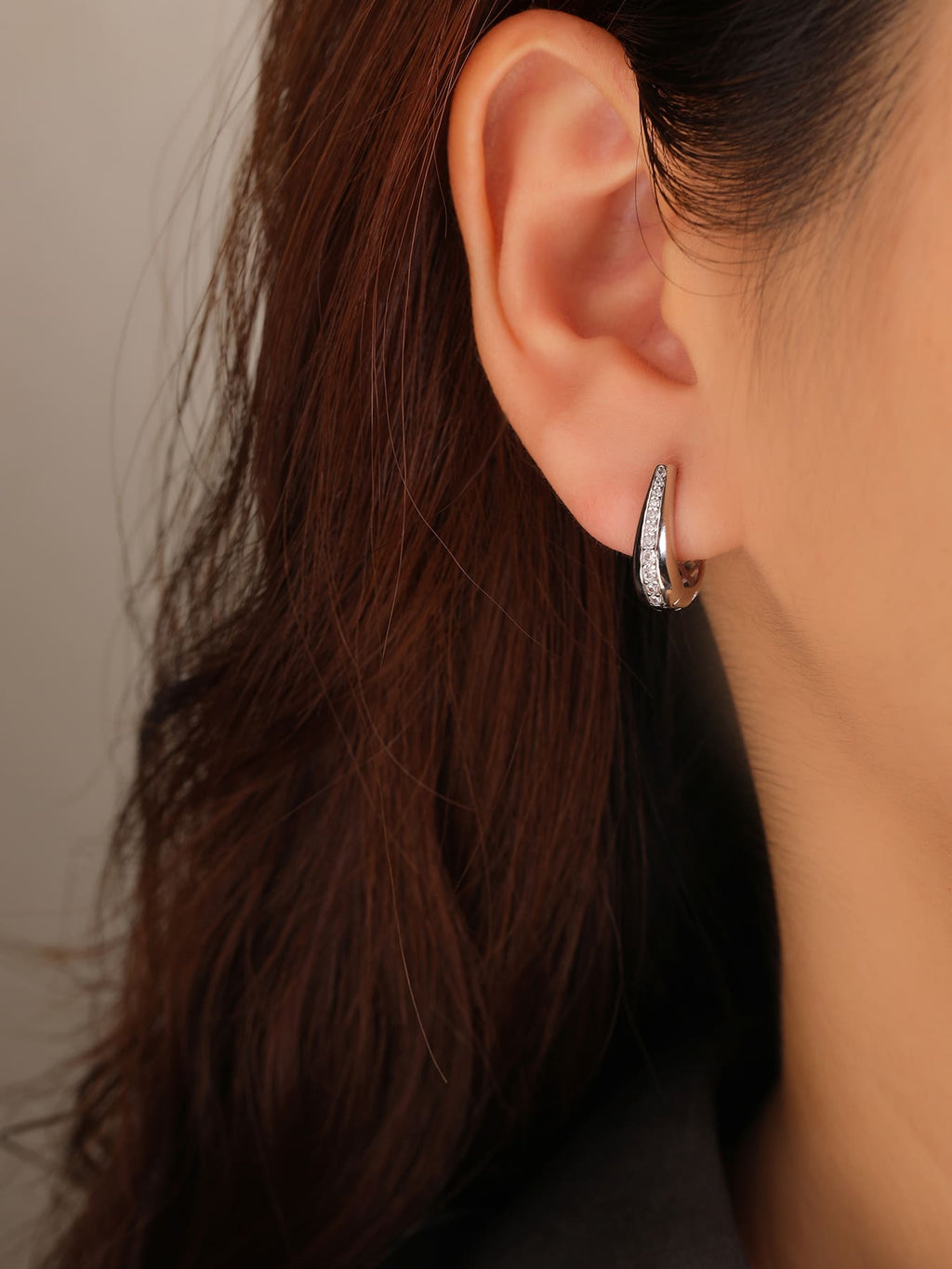 Double-row white cubic zirconia hoop earrings in hallmarked, rhodium-plated 925 sterling silver – worn view – DRESCHER Jewellery®