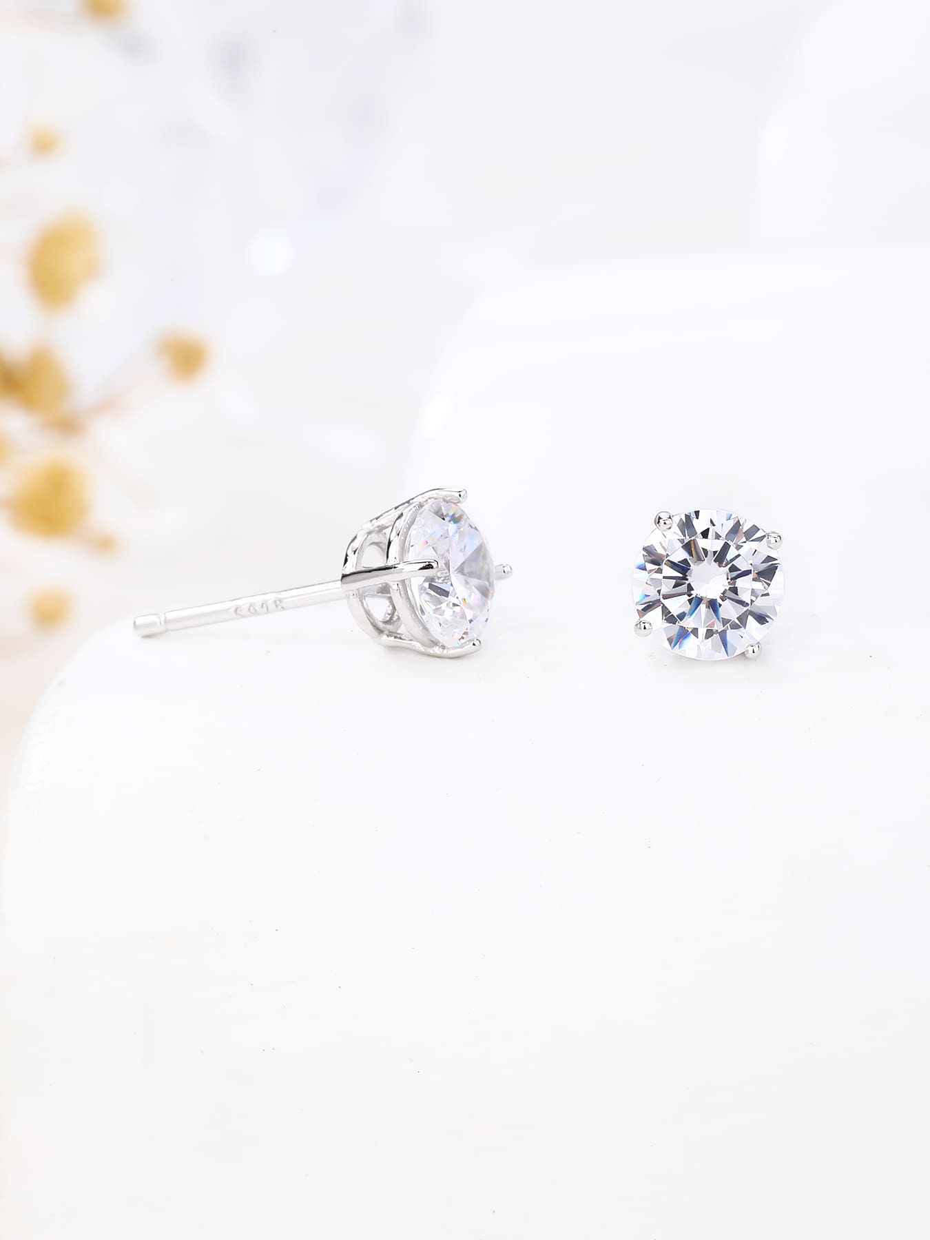 White solitaire cubic zirconia four-claw stud earrings in hallmarked, rhodium-plated 925 sterling silver – display view – DRESCHER Jewellery®