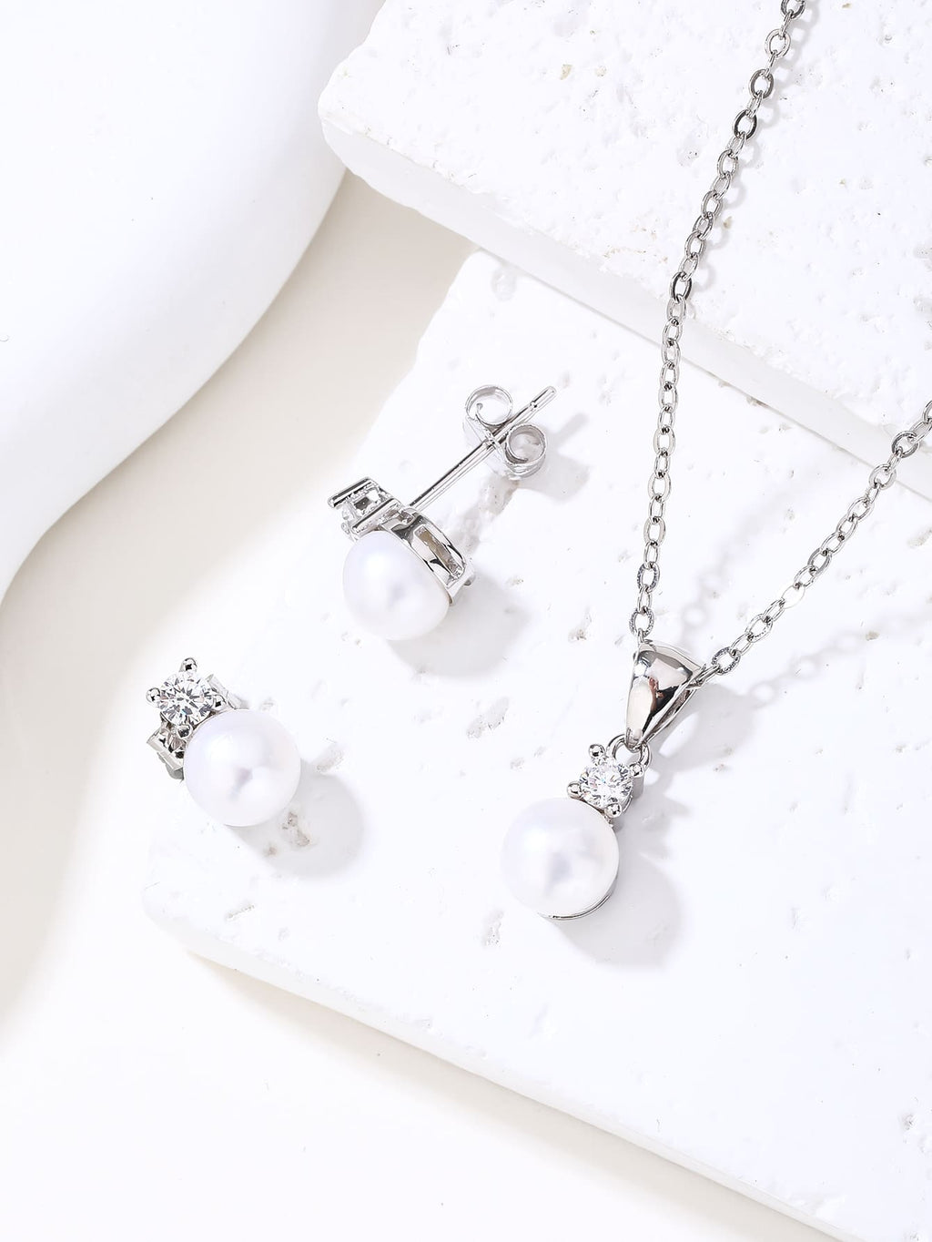White pearl and cubic zirconia jewellery set with silver components crafted from hallmarked, rhodium-plated 925 sterling silver – lifestyle arrangement – DRESCHER Jewellery®