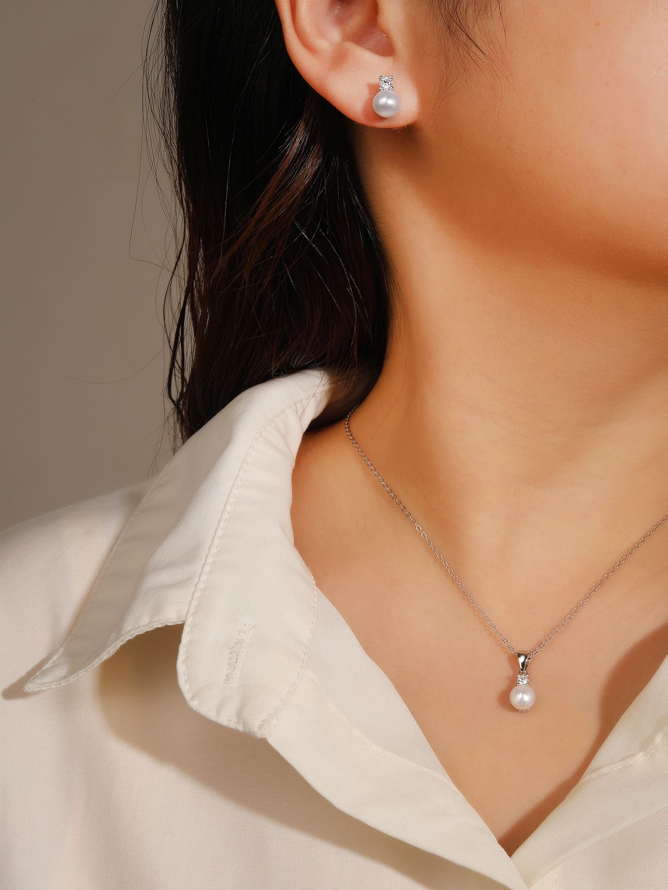 White pearl and cubic zirconia jewellery set with silver components crafted from hallmarked, rhodium-plated 925 sterling silver – worn view – DRESCHER Jewellery®