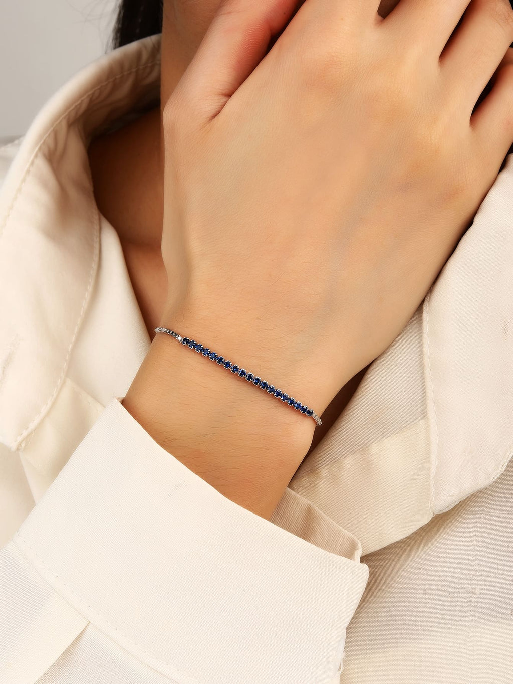 Bracelet with blue zirconia stones in hallmarked, rhodium-plated 925 sterling silver – worn view – DRESCHER Jewellery®