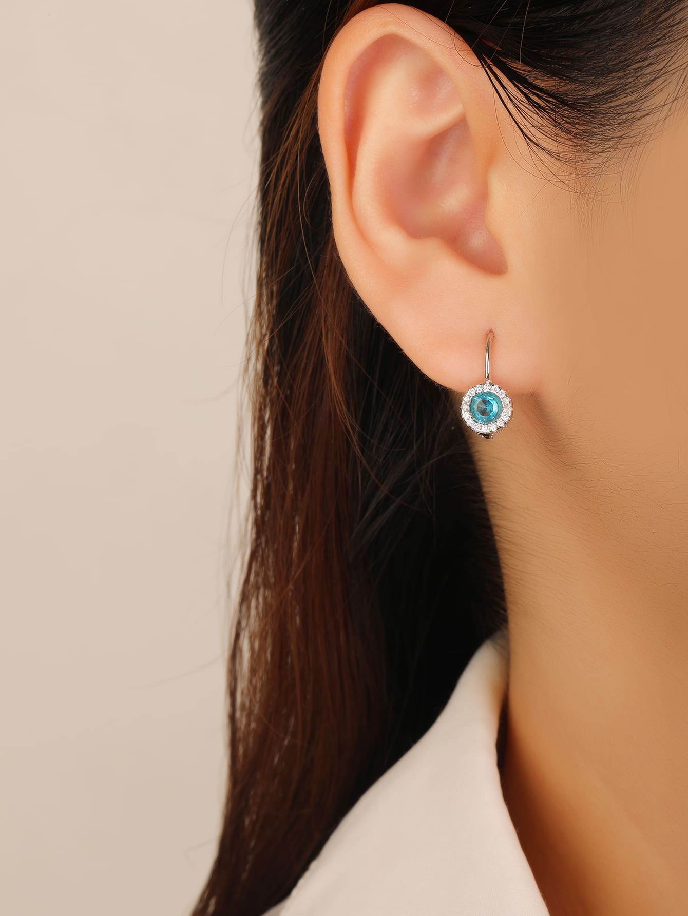 blue cubic zirconia stud earrings in hallmarked, rhodium-plated 925 sterling silver – worn view – DRESCHER Jewellery®
