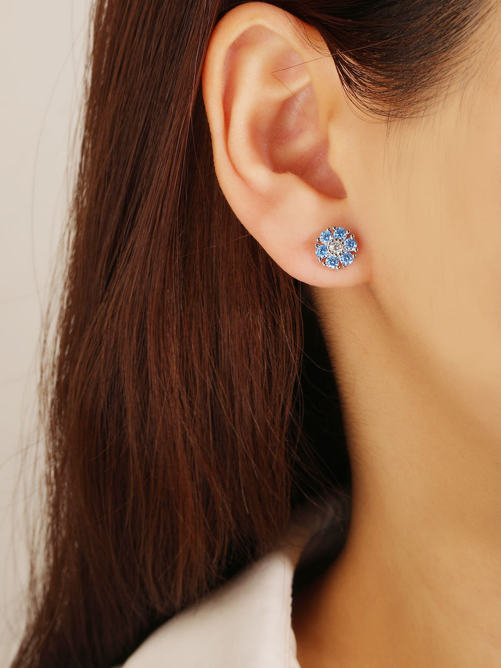 blue flower stud earrings in hallmarked, rhodium-plated 925 sterling silver – worn view – DRESCHER Jewellery®