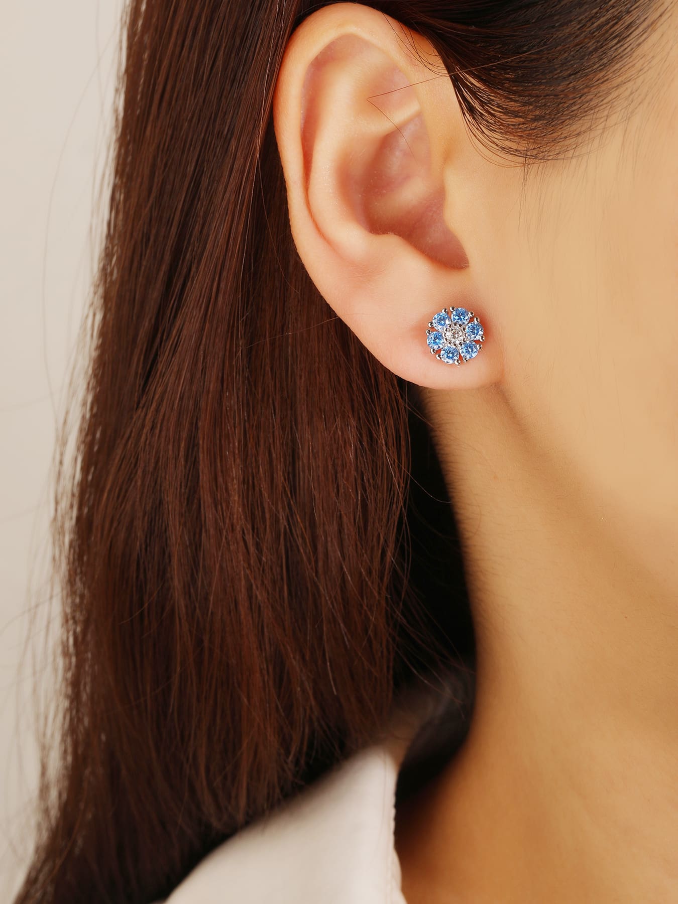 blue flower stud earrings in hallmarked, rhodium-plated 925 sterling silver – worn view – DRESCHER Jewellery®