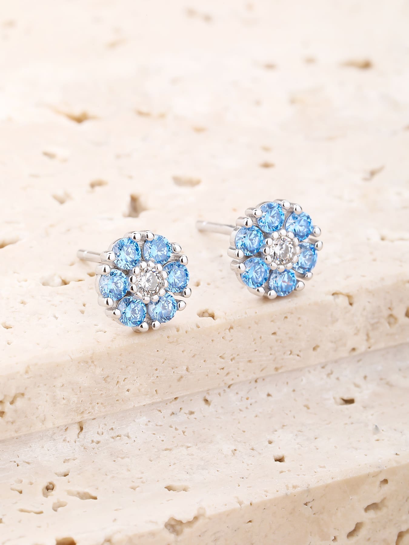 blue flower stud earrings in hallmarked, rhodium-plated 925 sterling silver – worn view – DRESCHER Jewellery®