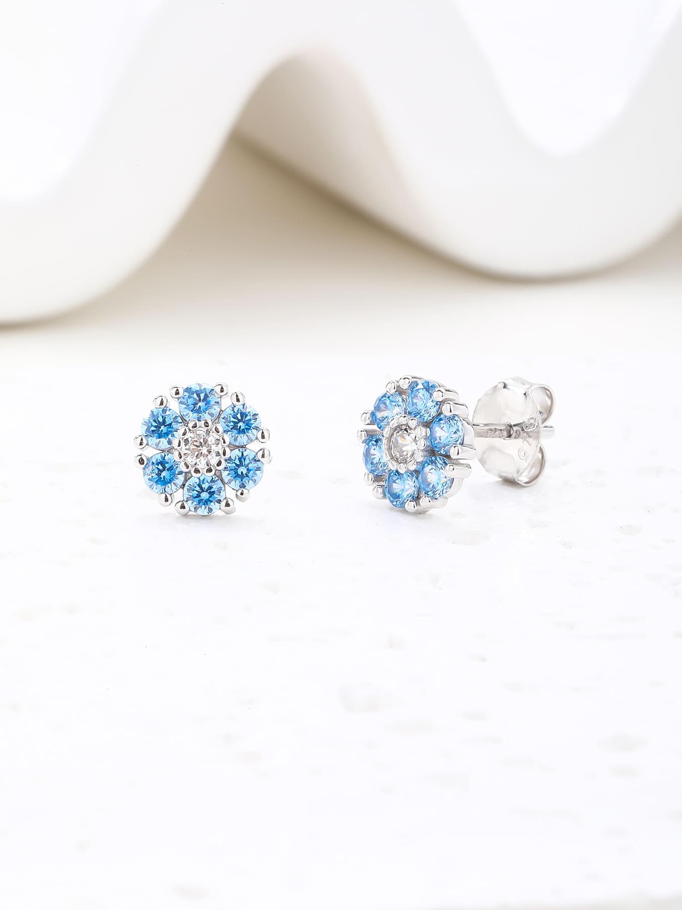 blue flower stud earrings in hallmarked, rhodium-plated 925 sterling silver – lifestyle view – DRESCHER Jewellery®
