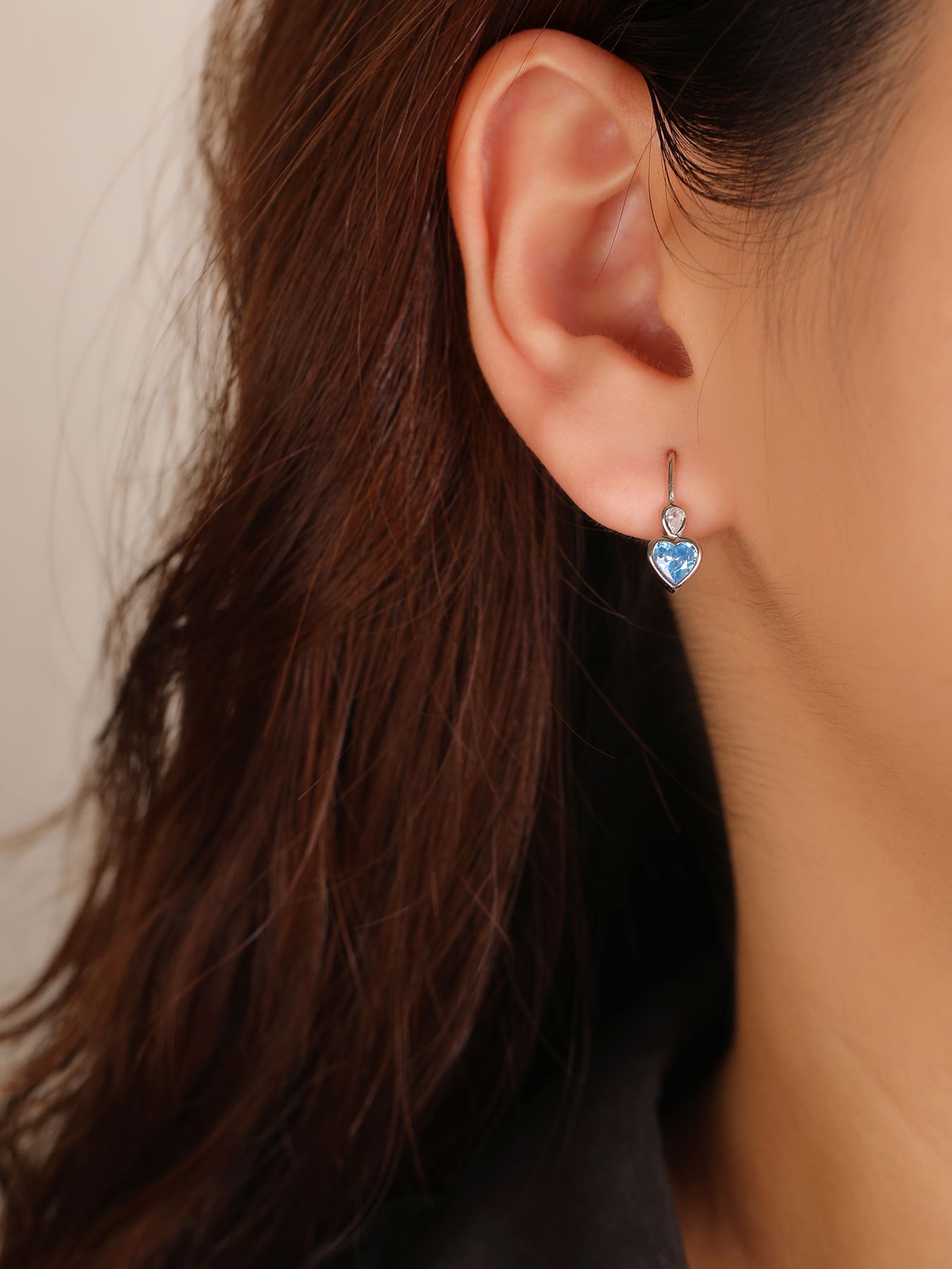 blue heart-shaped cubic zirconia children’s earrings in hallmarked, rhodium-plated 925 sterling silver – worn view – DRESCHER Jewellery®