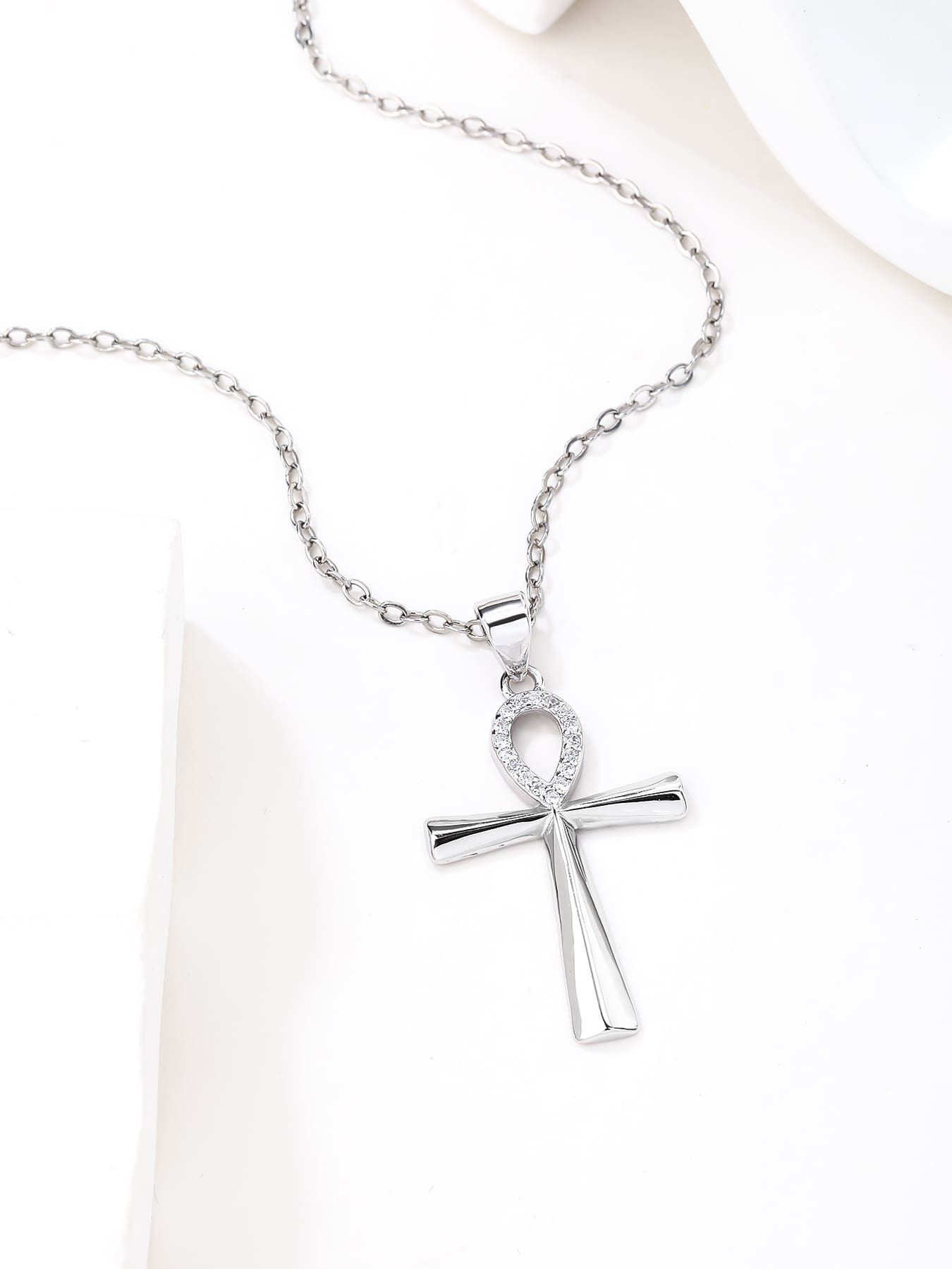 cubic zirconia Ankh cross pendant in hallmarked, rhodium-plated 925 sterling silver – lifestyle view – DRESCHER Jewellery®