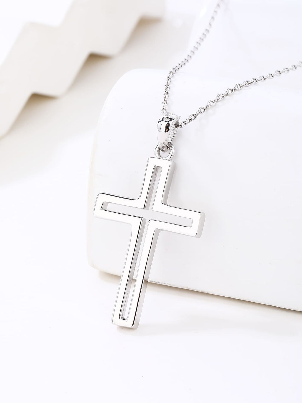 contoured cross pendant in hallmarked, rhodium-plated 925 sterling silver – lifestyle view – DRESCHER Jewellery®