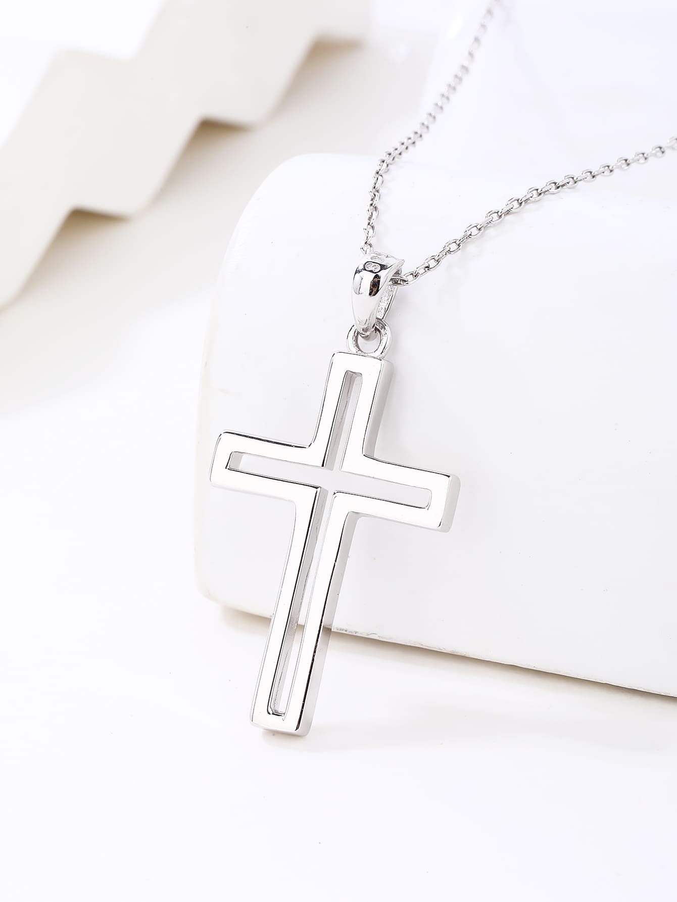 contoured cross pendant in hallmarked, rhodium-plated 925 sterling silver – lifestyle view – DRESCHER Jewellery®