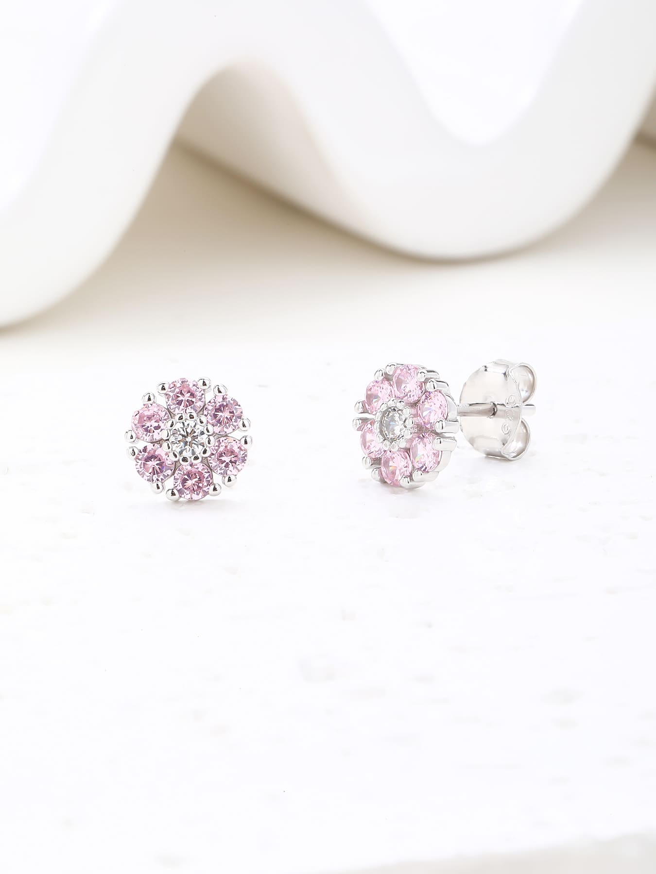 Pink and white cubic zirconia flower stud earrings in hallmarked, rhodium-plated 925 sterling silver – display view – DRESCHER Jewellery®