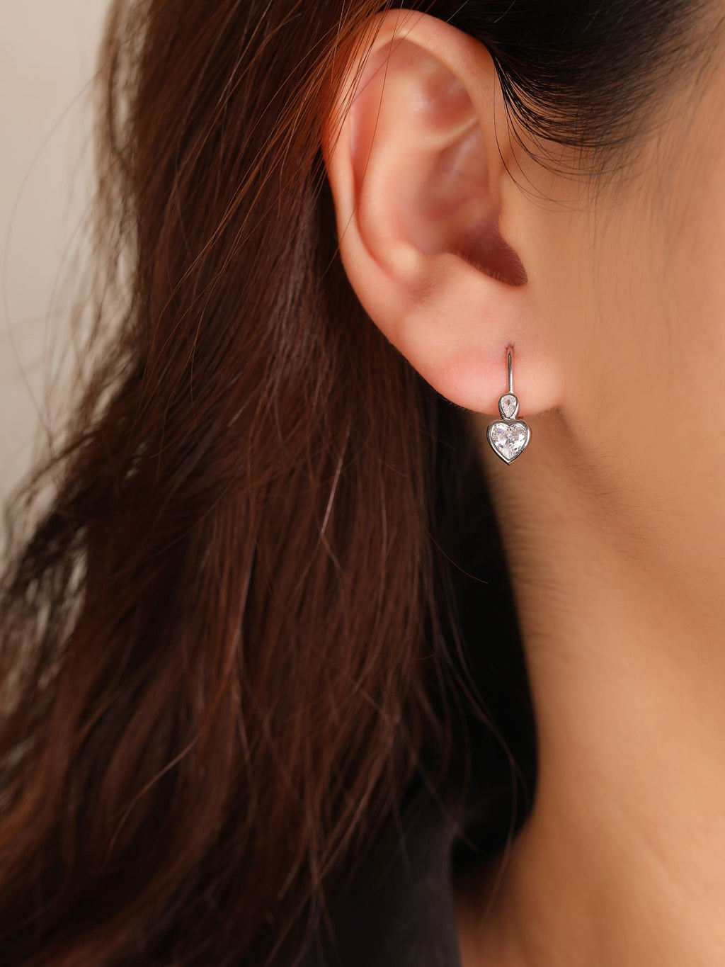 heart-shaped cubic zirconia children’s patent-closure earrings in hallmarked, rhodium-plated 925 sterling silver – worn view – DRESCHER Jewellery®