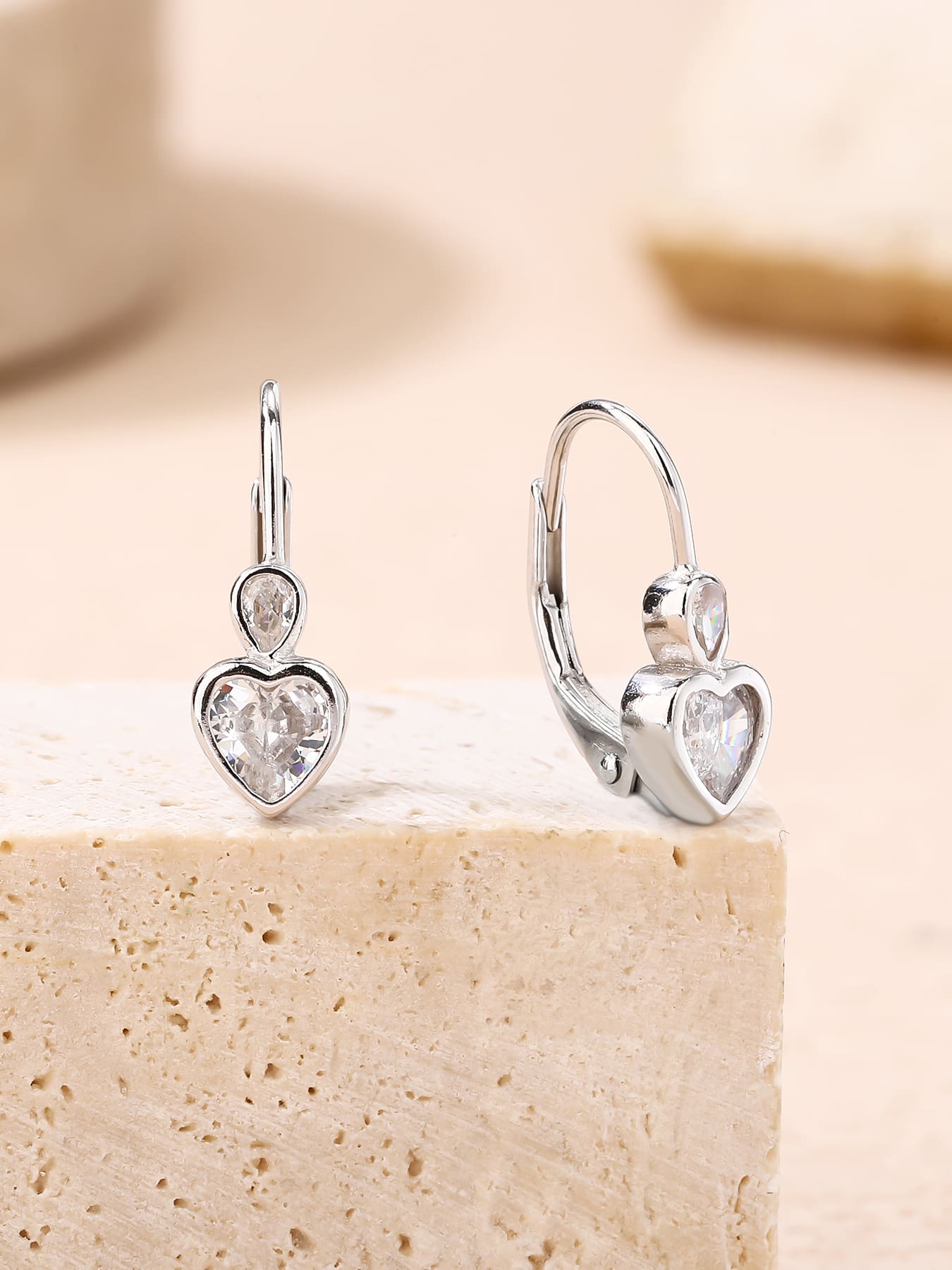 heart-shaped cubic zirconia children’s patent-closure earrings in hallmarked, rhodium-plated 925 sterling silver – lifestyle view – DRESCHER Jewellery®