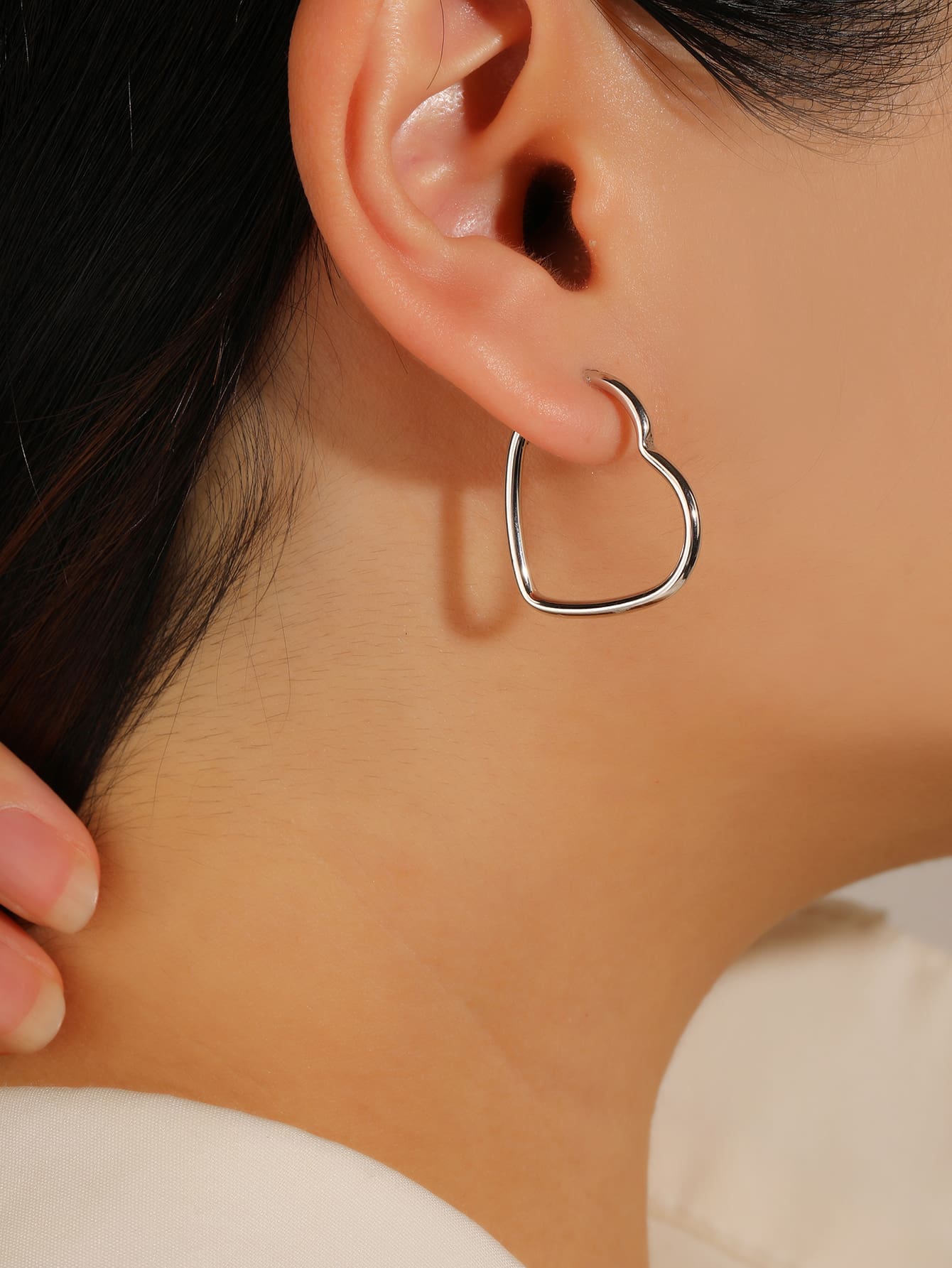 heart-shaped hoop earrings in hallmarked, rhodium-plated 925 sterling silver – worn view – DRESCHER Jewellery®