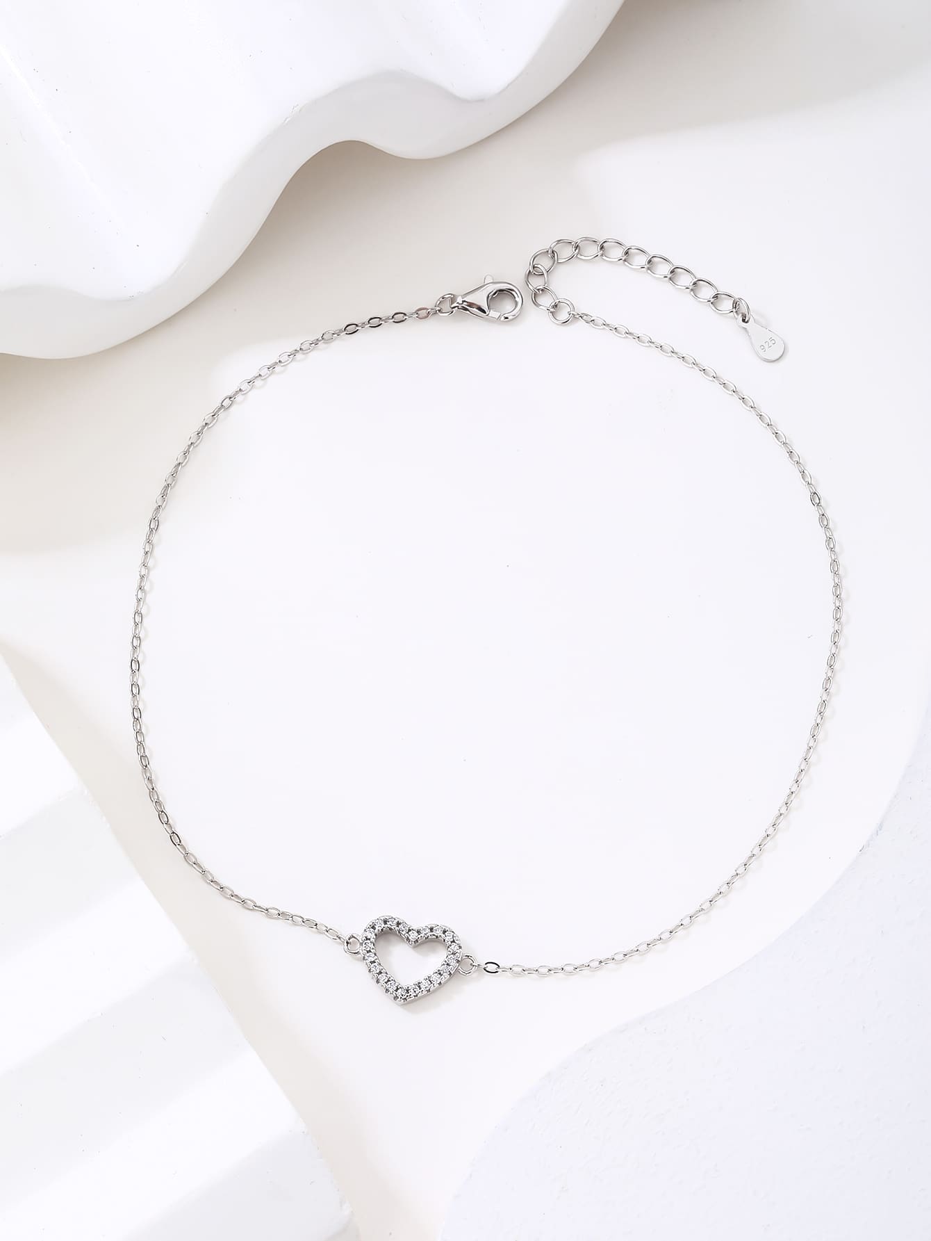 Zirconia stone bracelet with heart motif in hallmarked, rhodium-plated 925 sterling silver – worn view – DRESCHER Jewellery®
