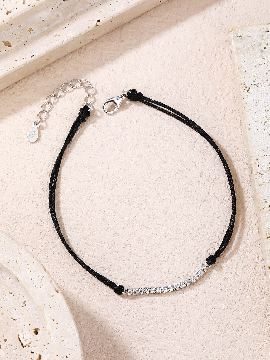 Tennis style zirconia bracelet with black cord - adjustable size (17 + 4 cm) with hallmarked, rhodium-plated 925 sterling silver motif – lifestyle view – DRESCHER Jewellery®