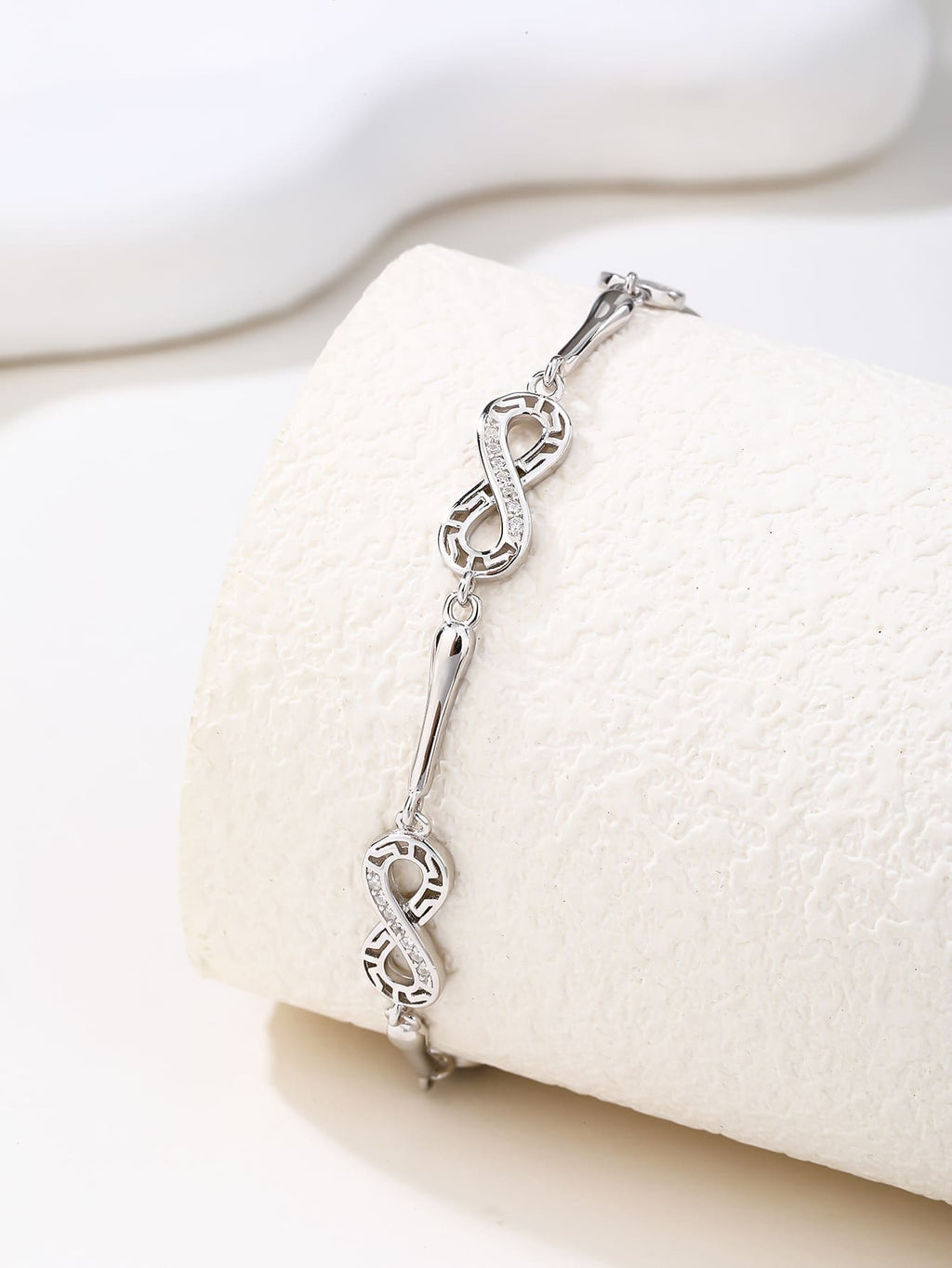 bracelet with infinity symbol and zirconia decoration in hallmarked, rhodium-plated 925 sterling silver – display view – DRESCHER Jewellery®