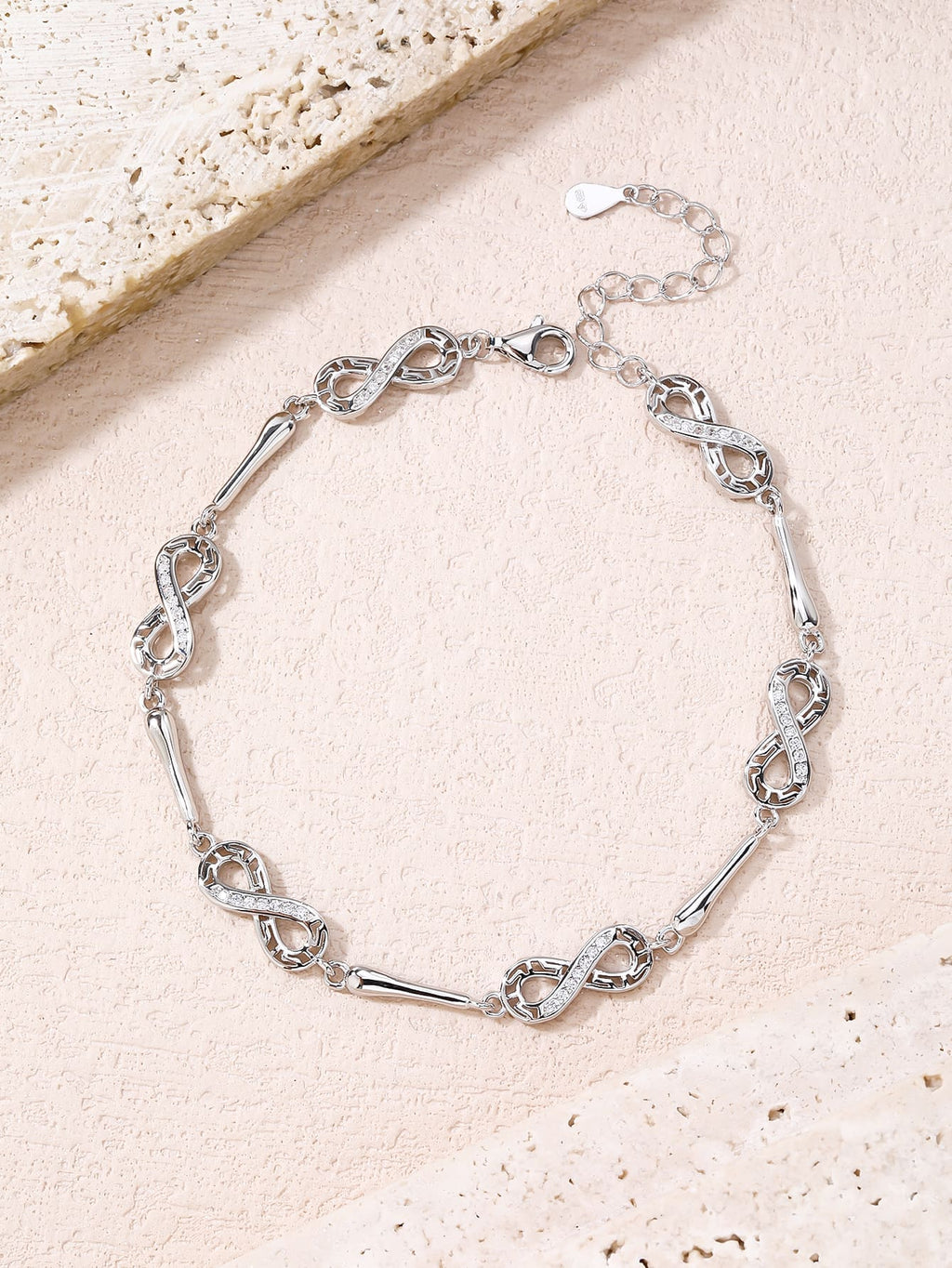 bracelet with infinity symbol and zirconia decoration in hallmarked, rhodium-plated 925 sterling silver – worn view – DRESCHER Jewellery®