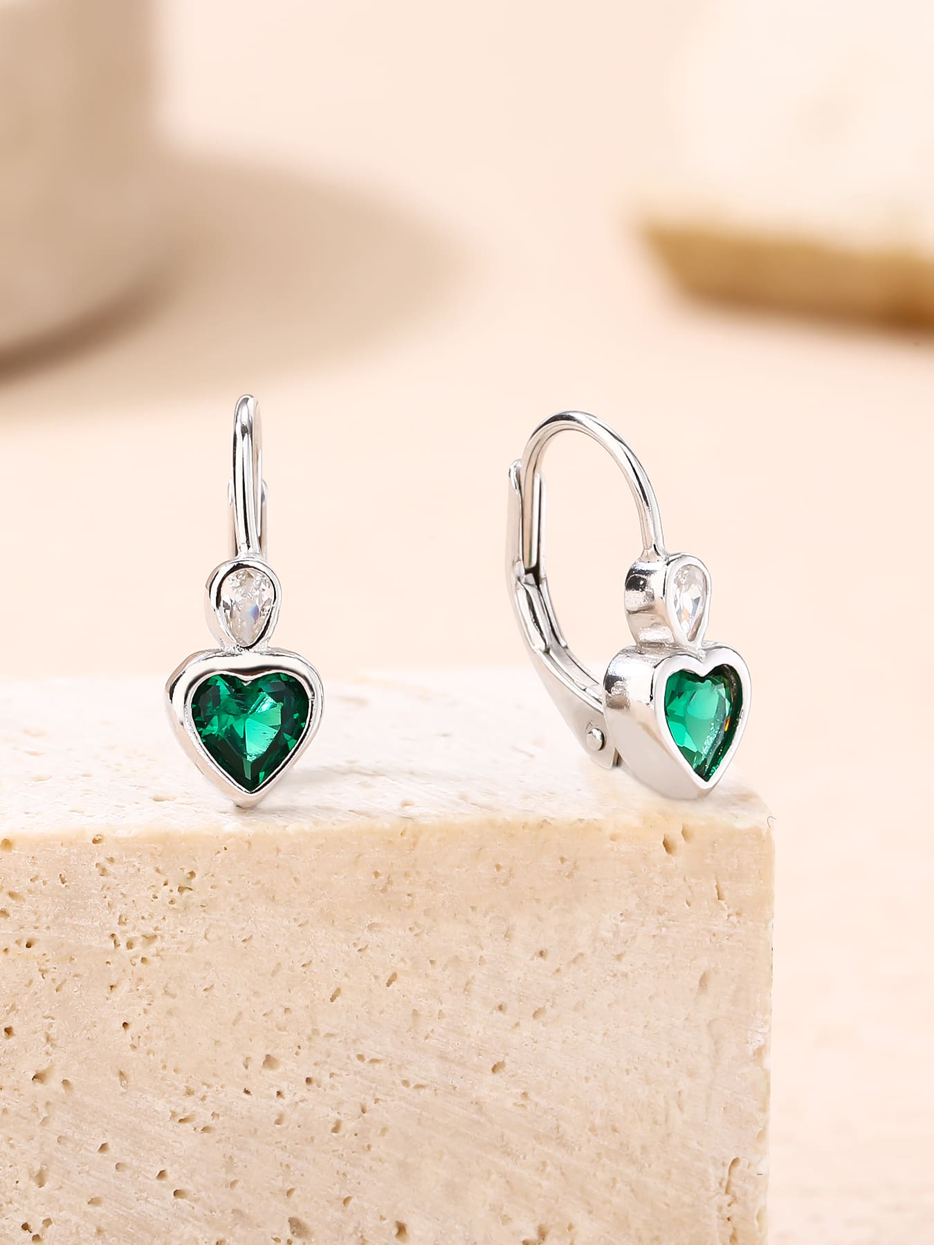 green heart-shaped cubic zirconia children’s earrings in hallmarked, rhodium-plated 925 sterling silver – lifestyle view – DRESCHER Jewellery®