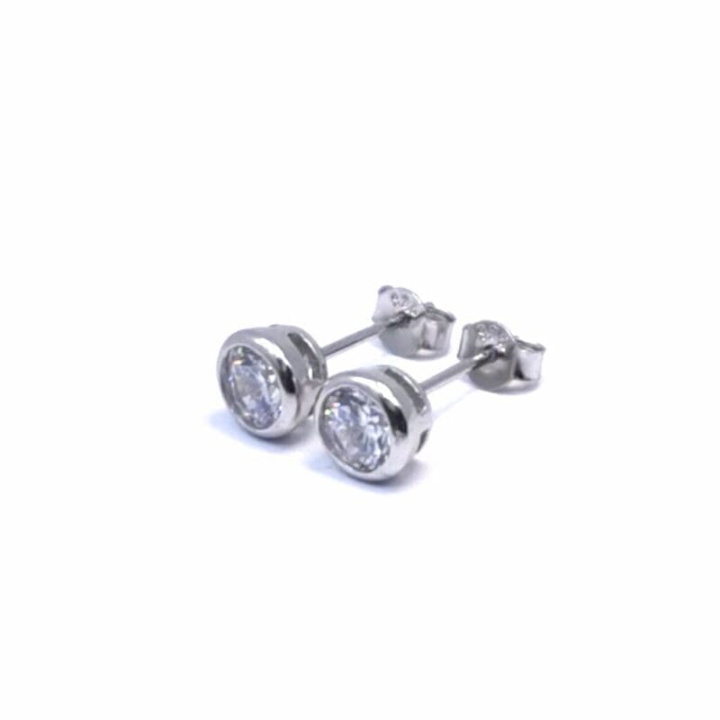 Round halo white stone stud earrings in hallmarked, rhodium-plated 925 sterling silver – angled view – DRESCHER Jewellery®